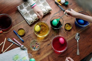 coloring_easter_eggs_with_supplies_on_the_table